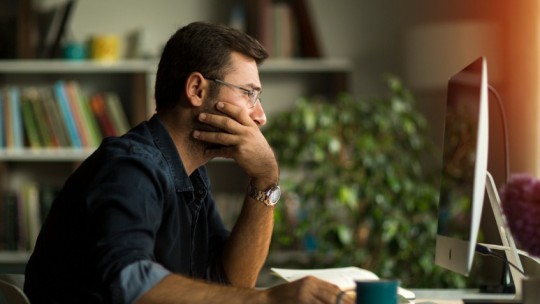 Man working from home with computer monitor