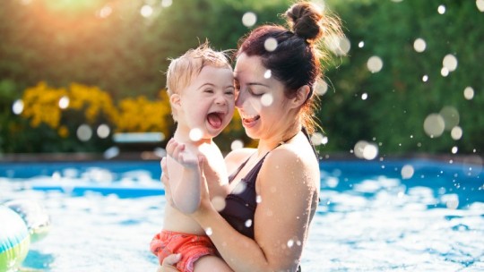 little boy with mom in pool