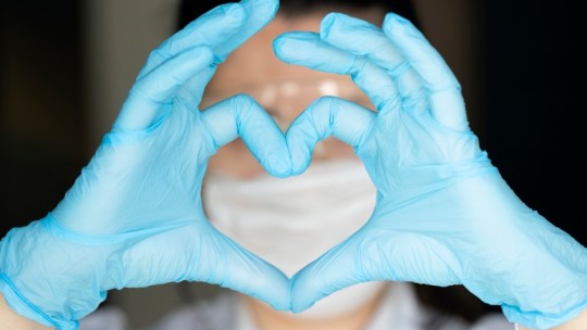 caregiver making heart with hands