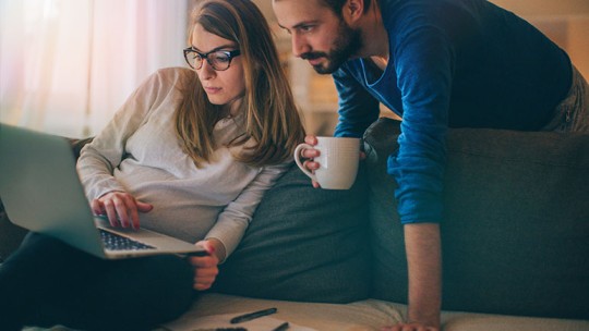 pregnant couple doing research online 