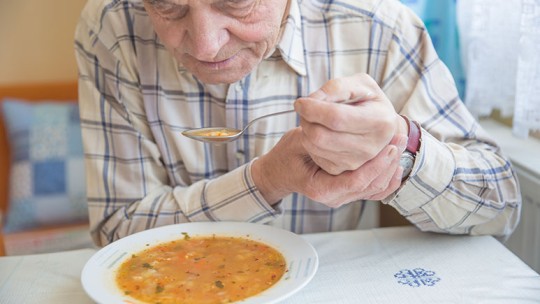 man with hand tremor 
