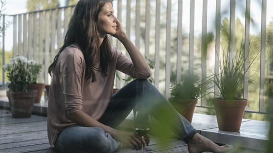 woman on deck drinking wine