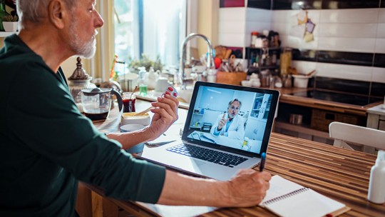 elderly man having telehealth visit 