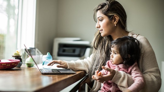 Mother and daughter on laptop at home
