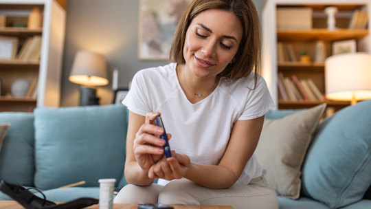 woman testing her blood sugar for diabetes