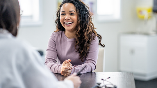 young woman speaking with provider