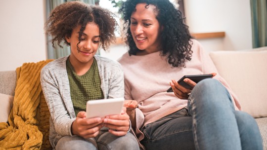 Mom and teen looking at mobile device