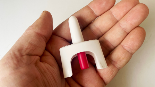 Hand holding Naloxene inhaler