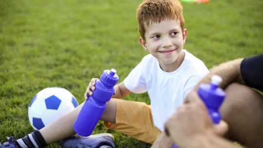 Young athlete taking a water break. 