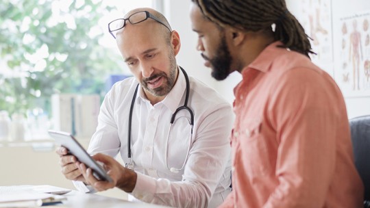 Primary care doctor and patient reviewing medical history