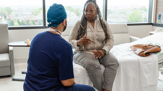 Hernia repair patient discussing with surgeon