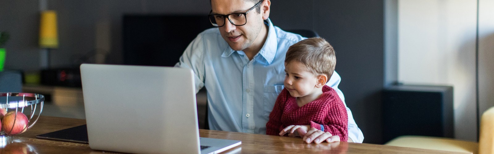 Dad and child looking at laptop