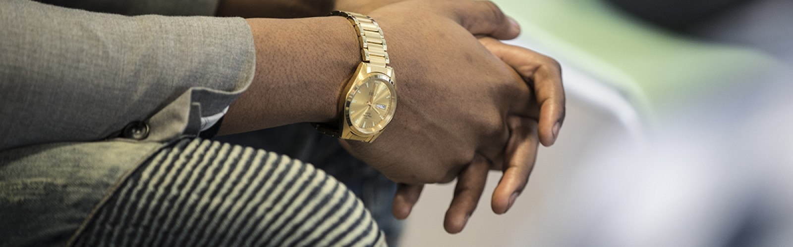 Hands together on a lap