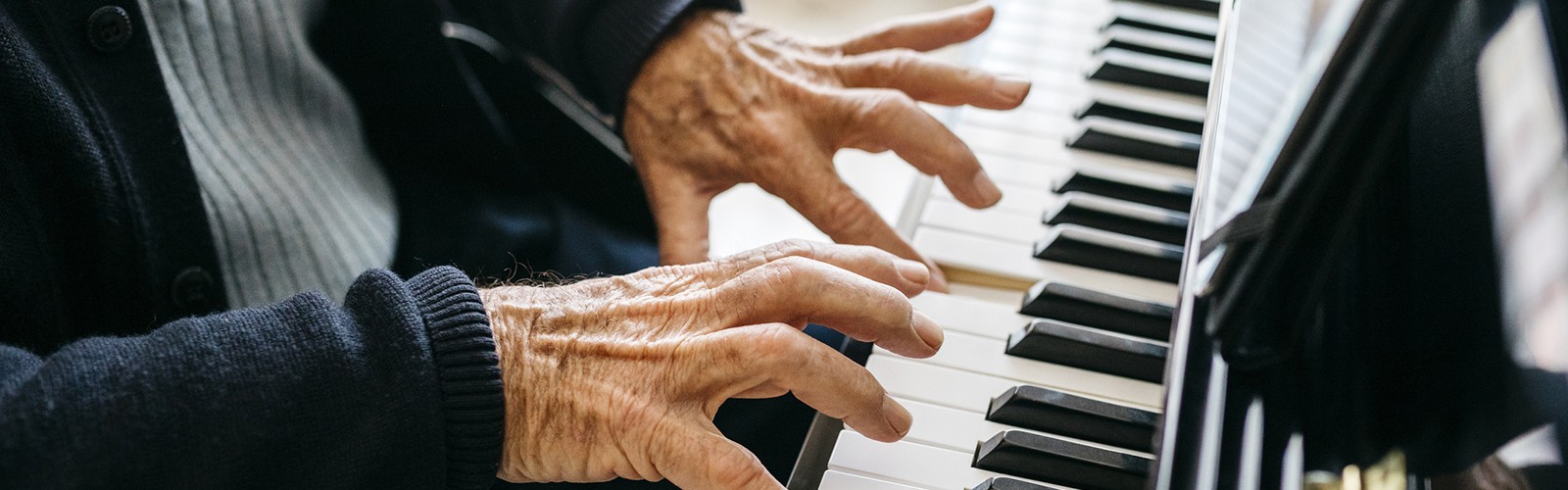Older hands playing piano