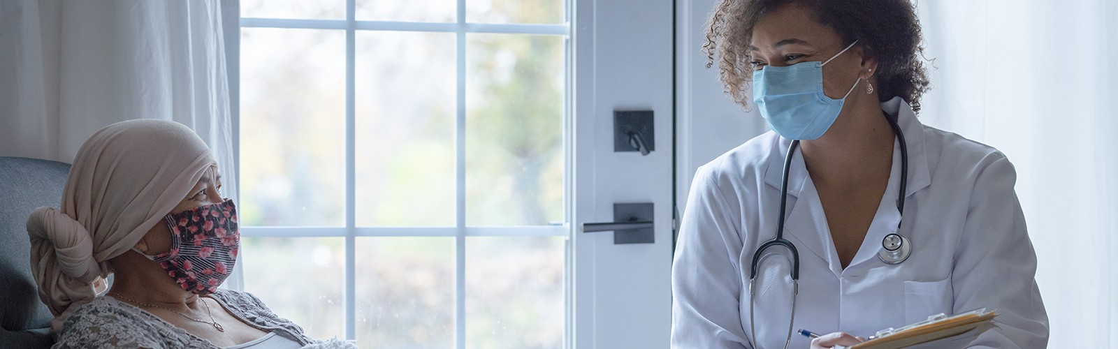 Cancer patient at home with doctor
