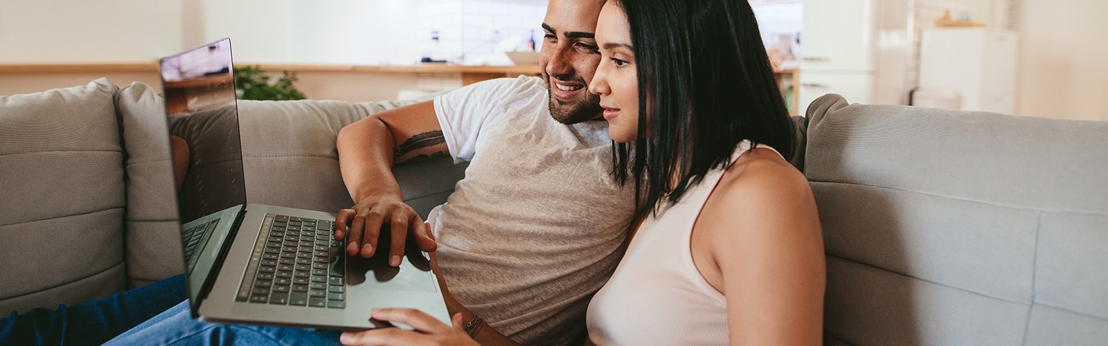Couple watching laptop at home