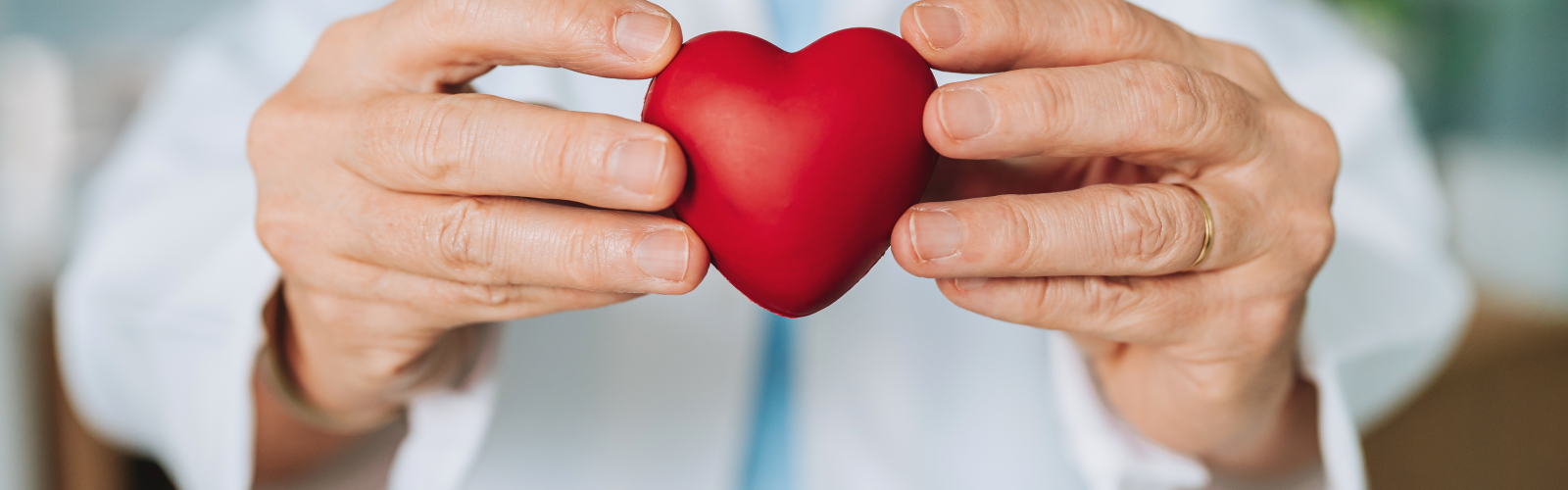 Caregiver holds a heart in between her two hands