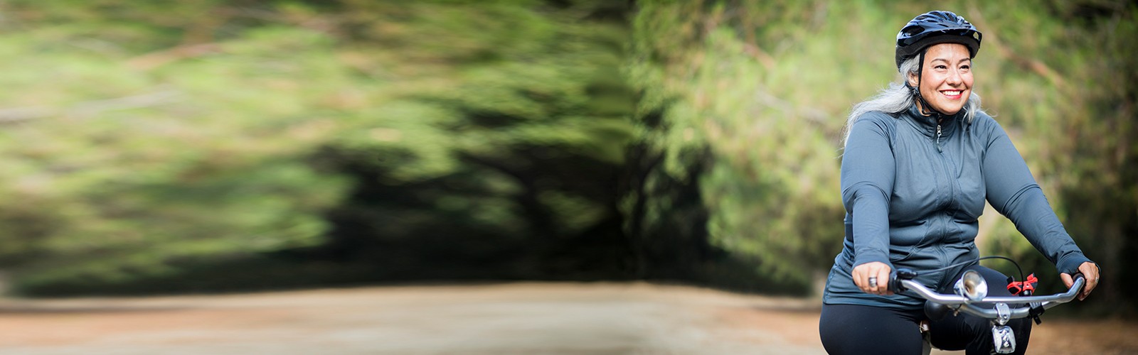 Healthy senior woman riding her bike