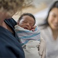 doula holding newborn baby