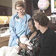 midwife with baby and parents
