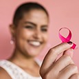 Woman holding up breast cancer ribbon