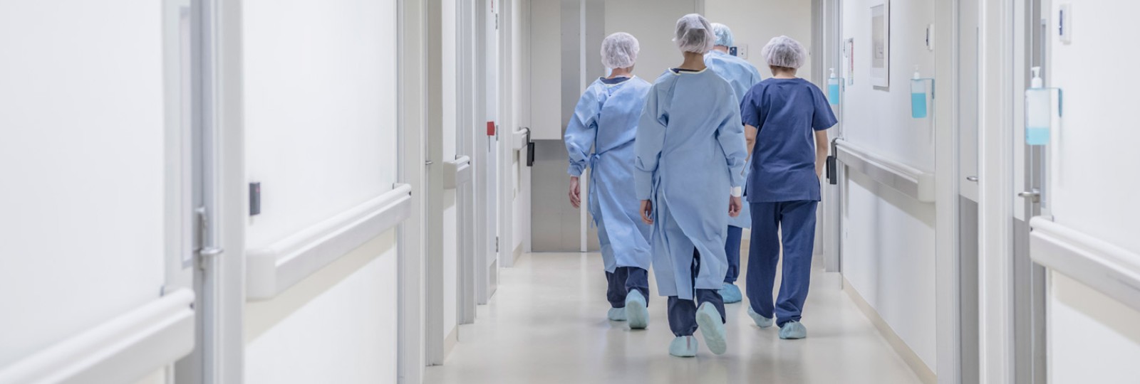 Group of surgeons walking down a hospital hallway