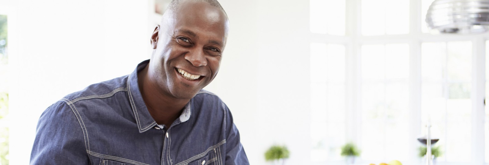 African American man in his 40s smiling in home kitchen