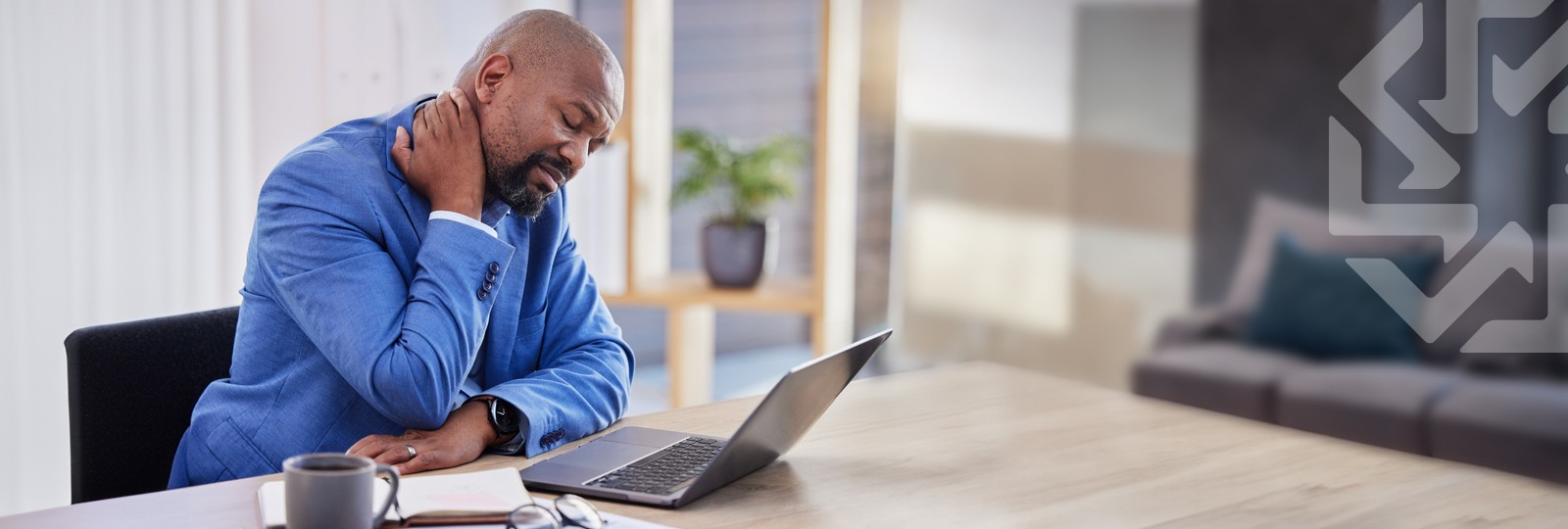 Person with neck pain working on a laptop