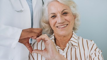 Women with doctor with hands in heart shape