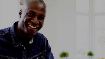 African American man in his 40s smiling in home kitchen