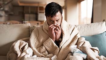 Man blowing his nose