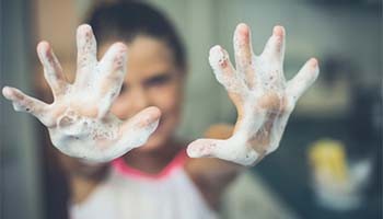 Little girl washing her hands