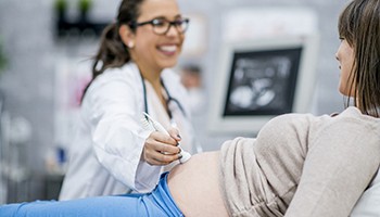Pregnant woman getting ultrasound